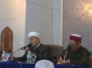 Sheikh Dr. Wahbah az-Zuhaili berserban putih menyampaikan syarahan di meja bersama penterjemah di Masjid Shah Alam